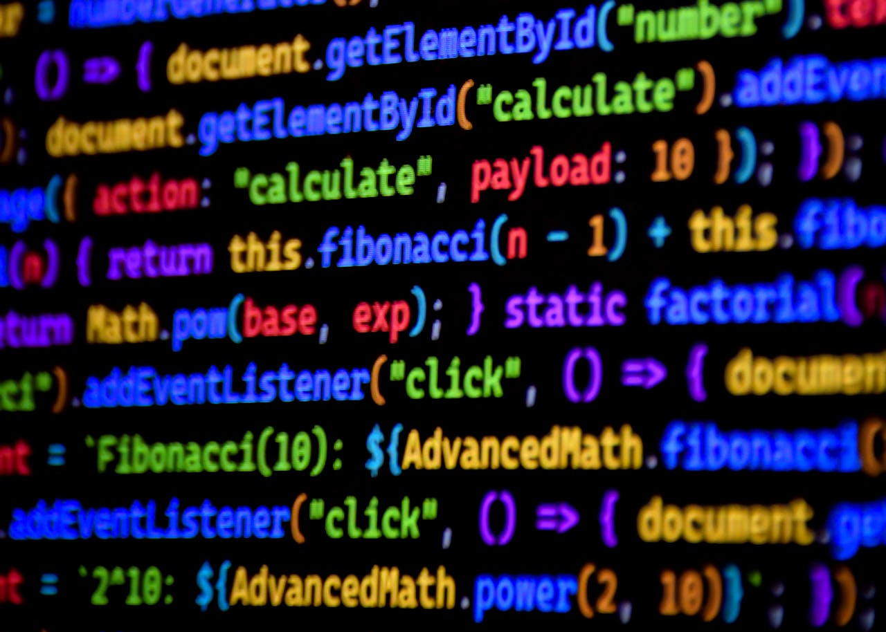 why-choose-us Bright and colorful JavaScript code displayed on a computer screen, showcasing programming.